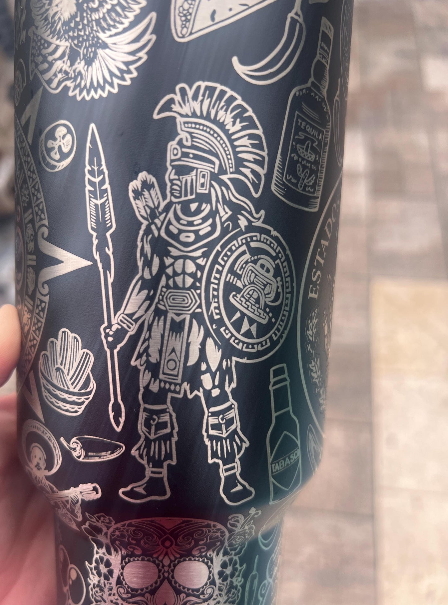 Close-up of Aztec warrior engraving from a highly detailed Mexican heritage wrap on a Black Stanley 40oz Quencher H2.0.