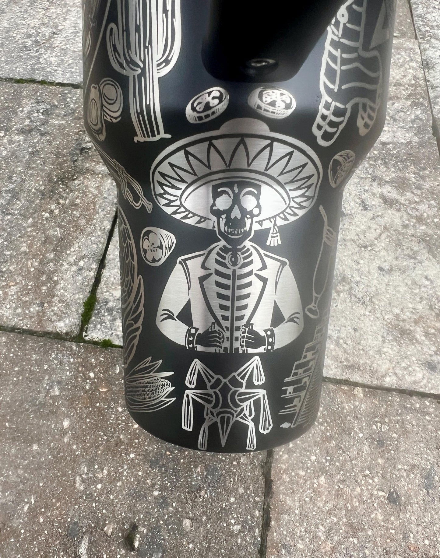 Sugar skull, peppers, and sombrero skeleton with jacket engraving in a Mexican heritage wrap on a Black Stanley 40oz Quencher H2.0 personalized tumbler.