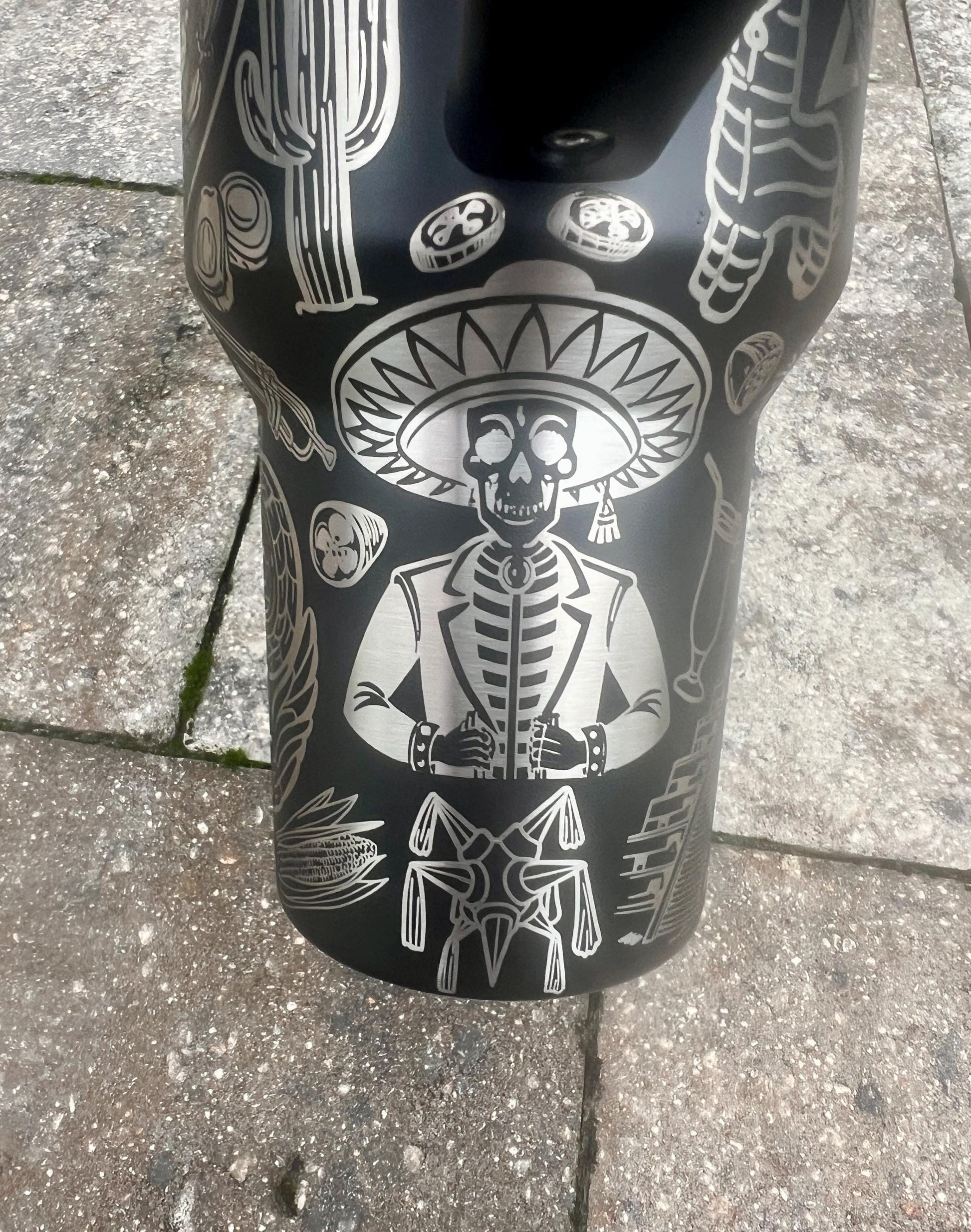 Sugar skull, peppers, and sombrero skeleton with jacket engraving in a Mexican heritage wrap on a Black Stanley 40oz Quencher H2.0 personalized tumbler.