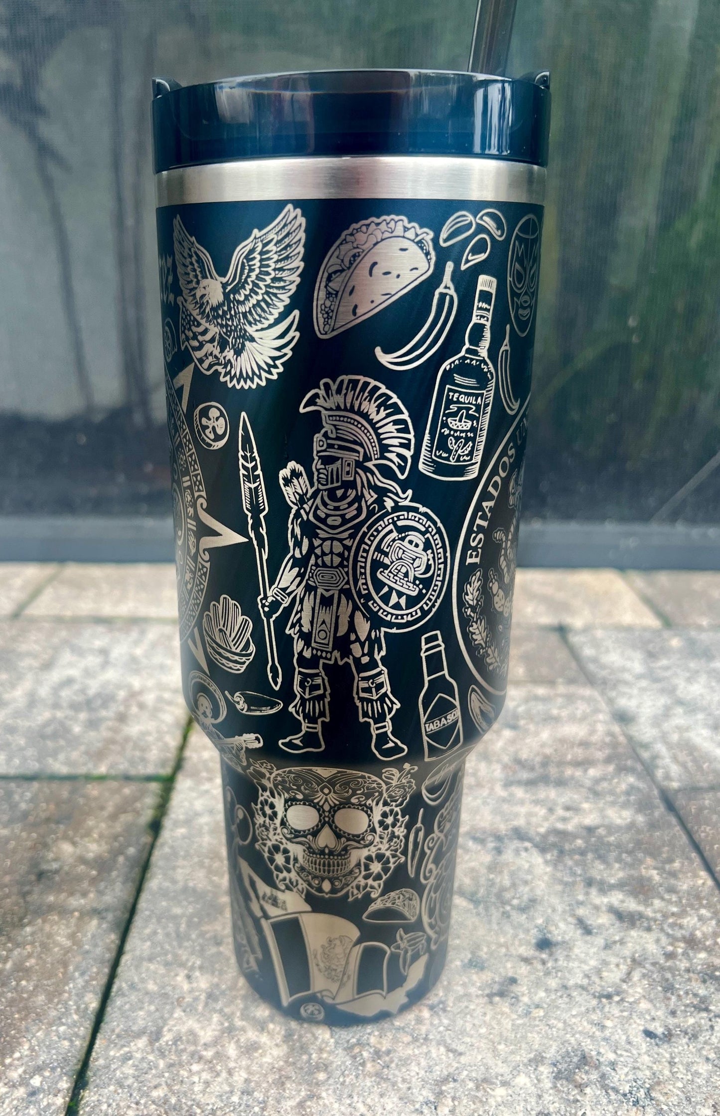 Aztec warrior, tequila bottle, hot sauce, taco, sugar skull, and eagle engraving in a detailed Mexican heritage wrap on a Black Stanley 40oz Quencher H2.0